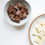 White and milk chocolate chips symbolizing the delicious flavors of nuwave protein supplements