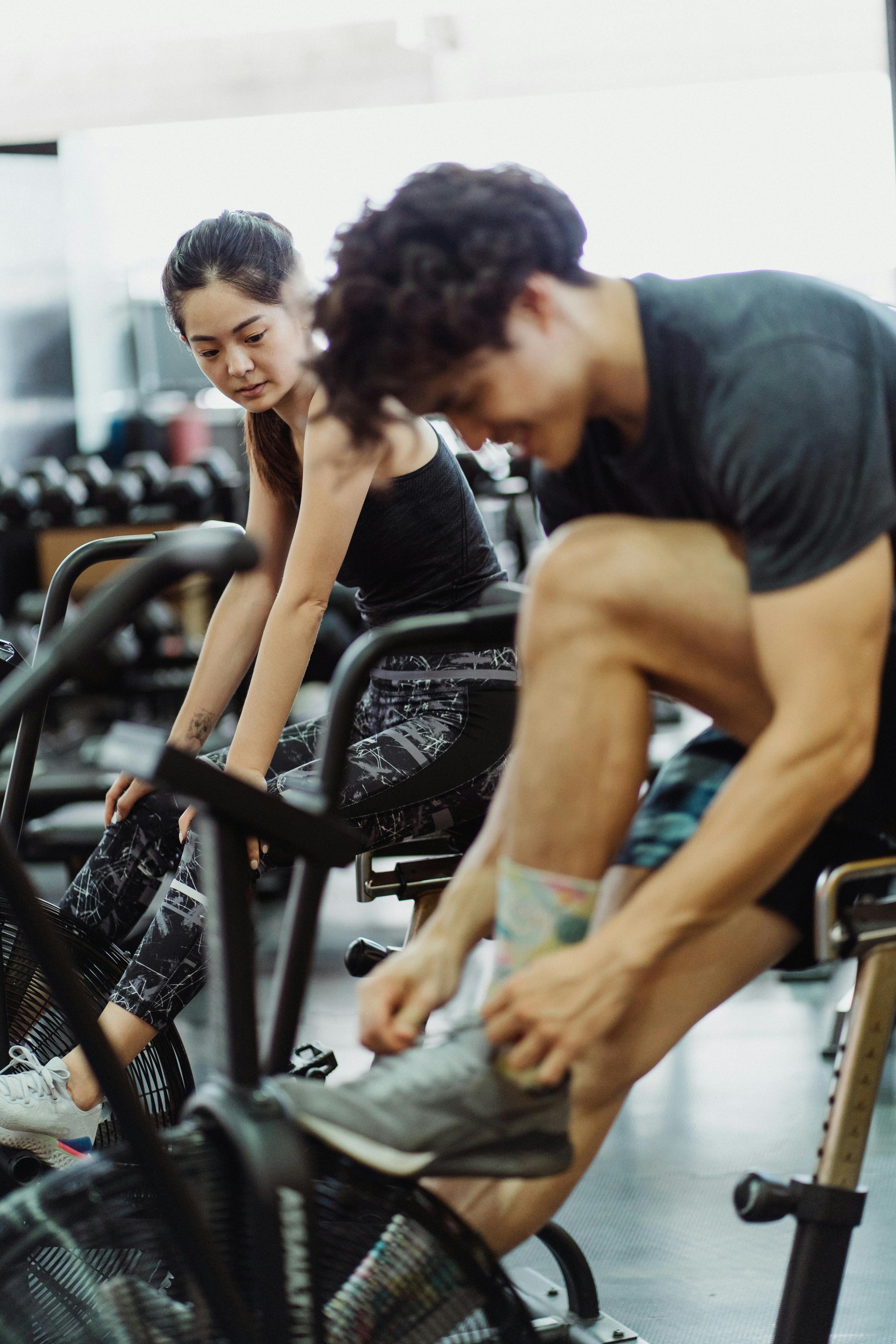 Man and woman cycling at the gym sybolizing the healthy active lifestyle that nuwave products support