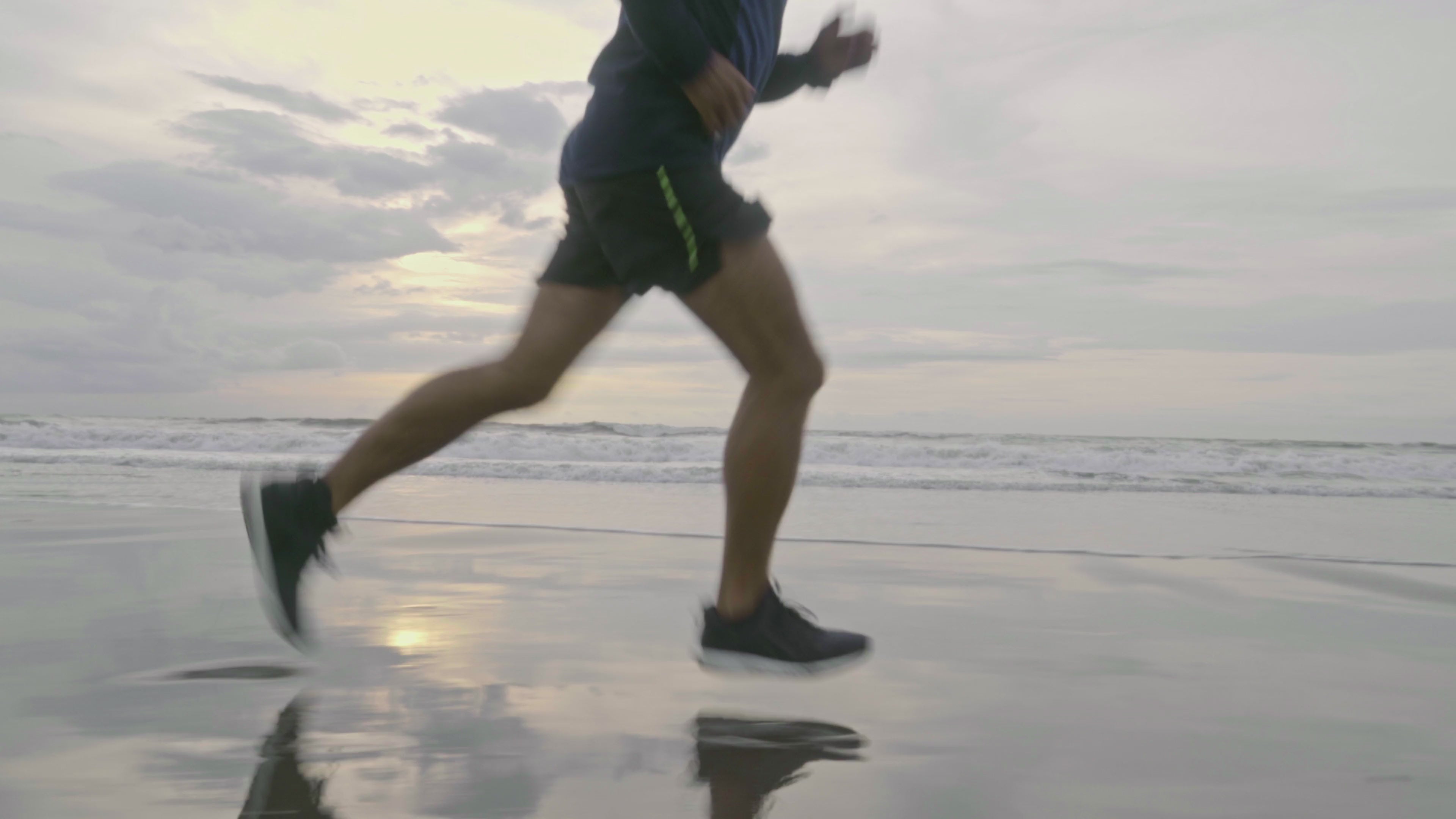 Man running on the beach before enjoying a nuwave protein shake to support his post workout recovery